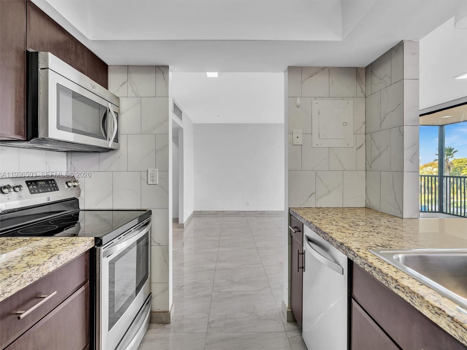 Photo of #521, Aventura, Florida, 33180 - View into Kitchen with granite countertops and stainless steel appliances