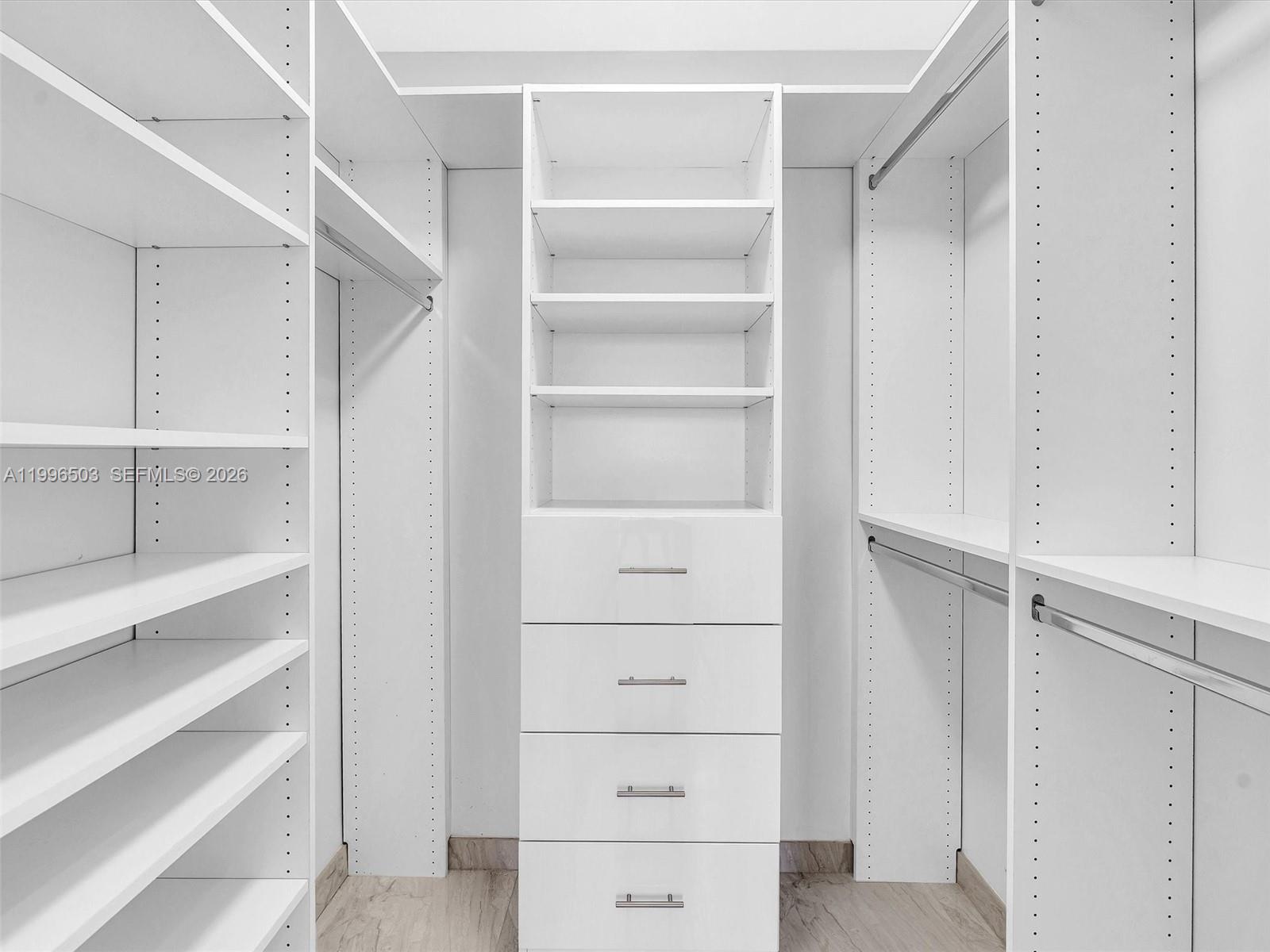 Photo of #521, Aventura, Florida, 33180 - Custom walk-in closet with built-in shelving and drawers