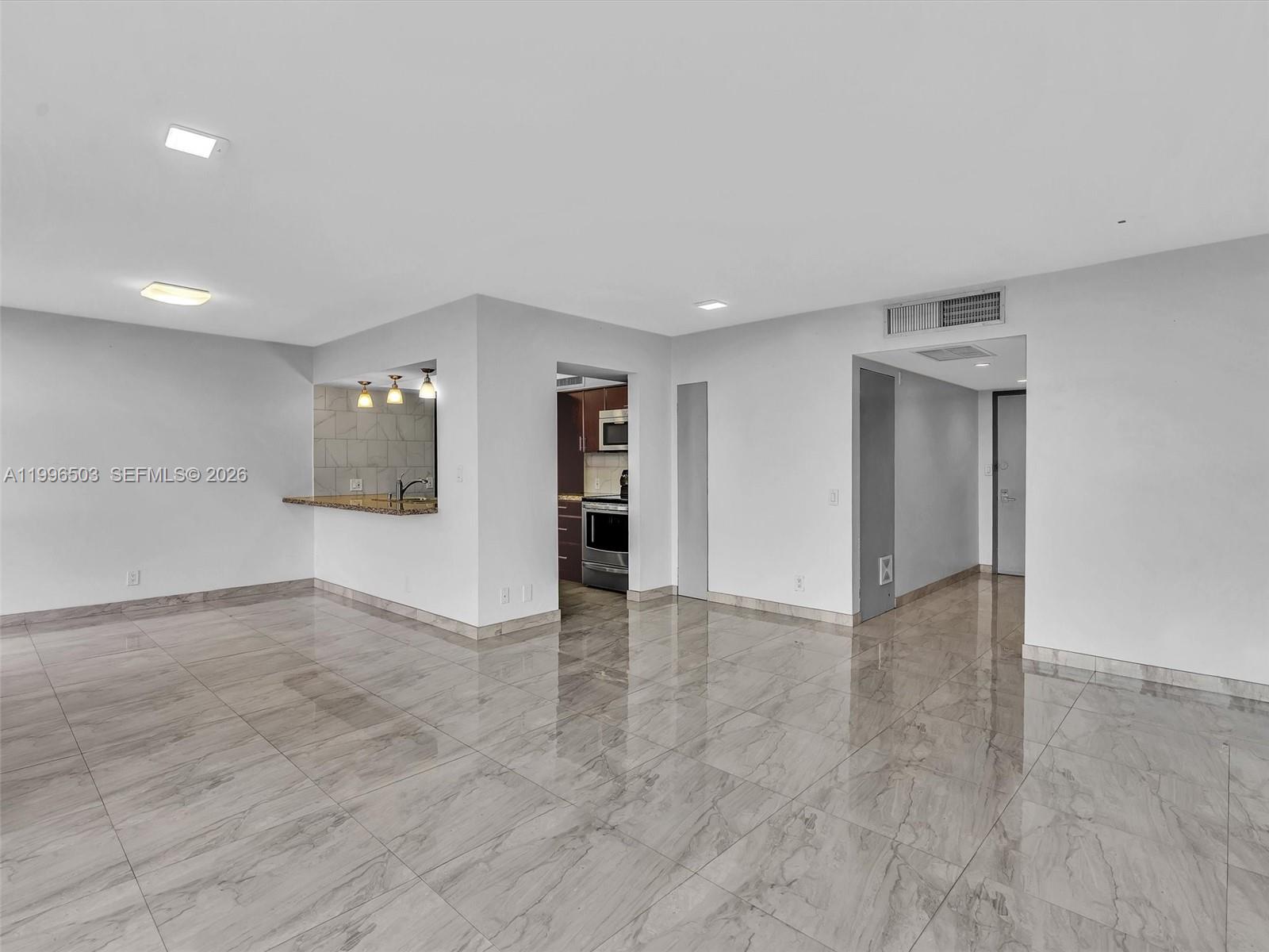 Photo of #521, Aventura, Florida, 33180 - Living room from another angle showing open layout and Kitchen access