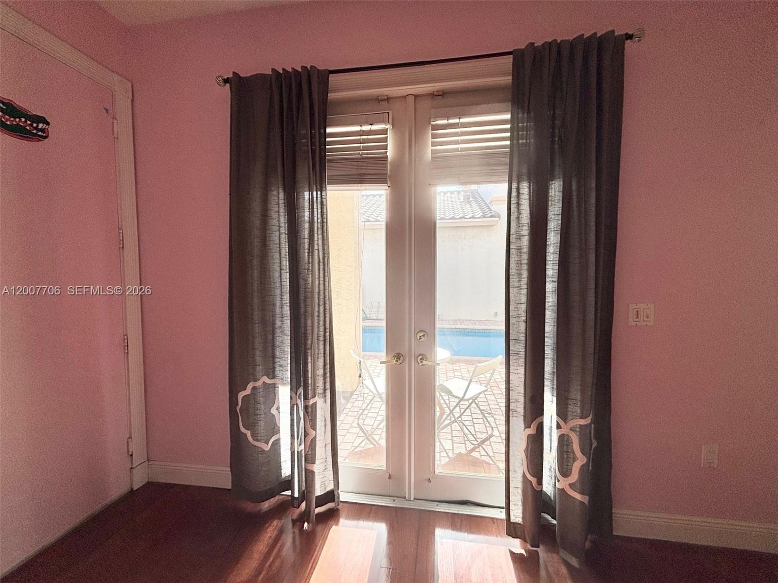 Photo of 1141 Waterside Ln  (1141), Hollywood, Florida, 33019 - Bedroom has french doors overlooking the pool