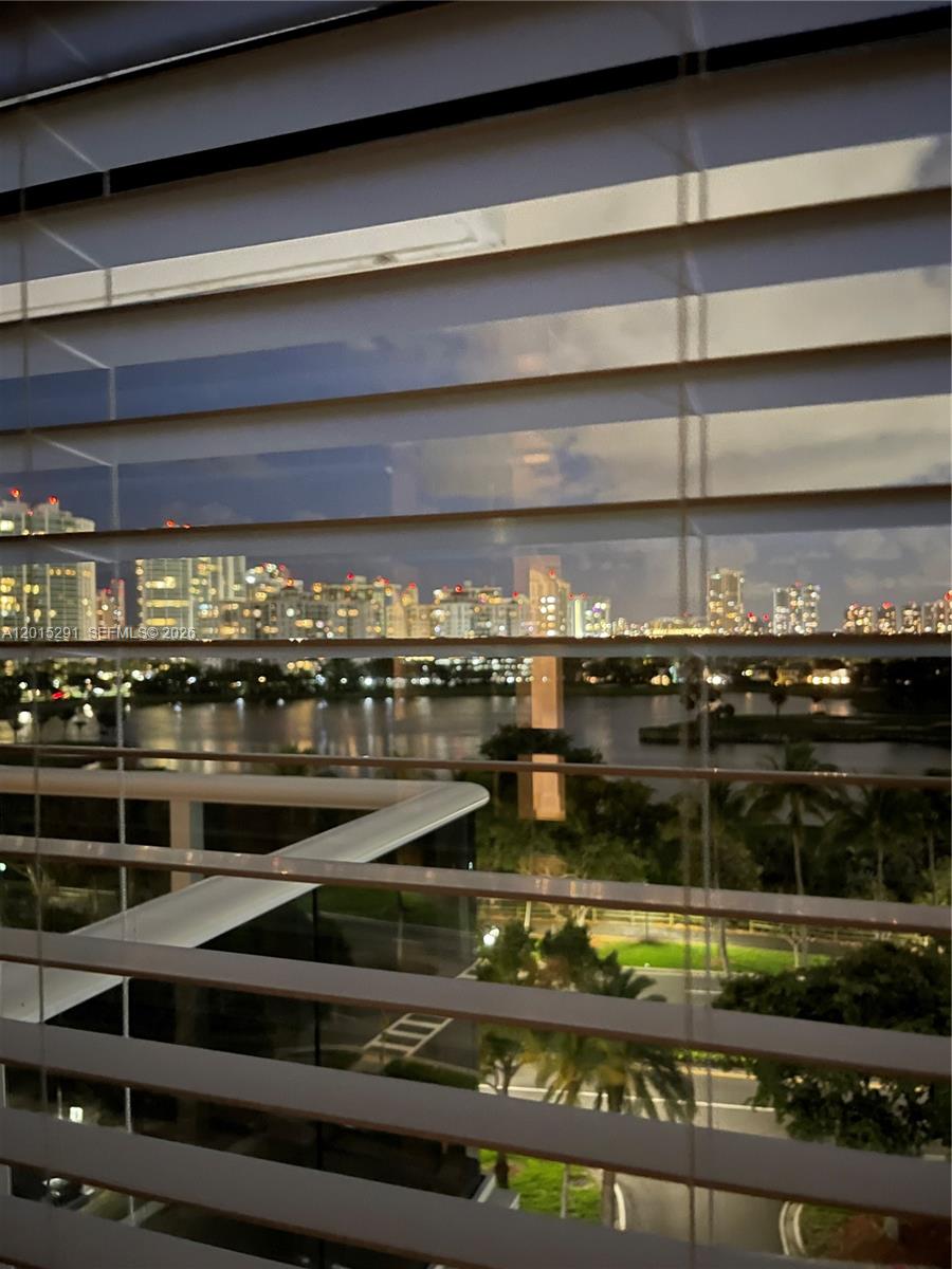 Photo of 3625 Country Club Dr #907, Aventura, Florida, 33180 - Evening View through Bedroom Window Blinds