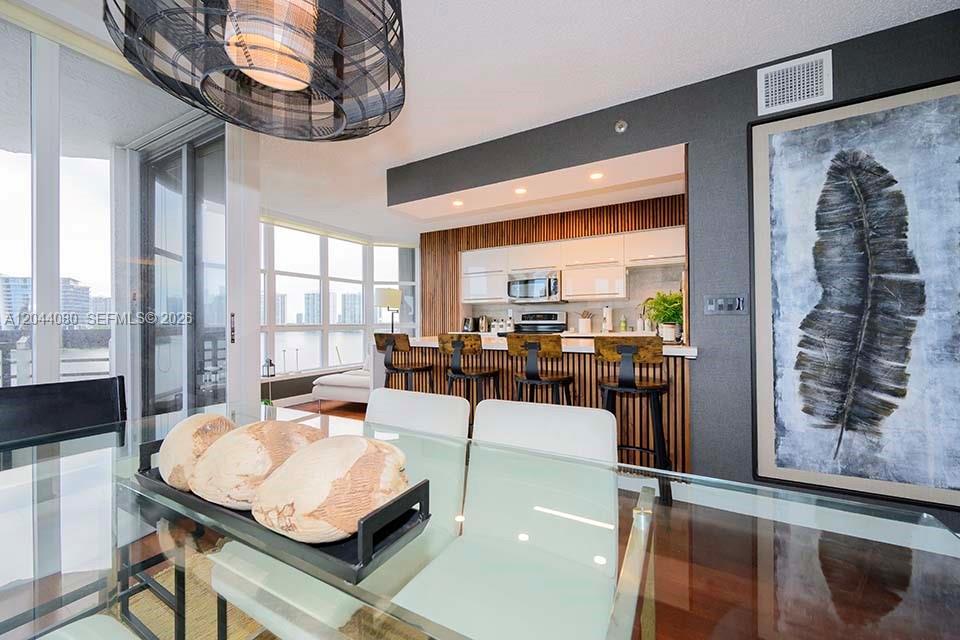 Photo of 3600 Mystic Pointe Dr  #718, Aventura, Florida, 33180 - Dining room open to modern kitchen