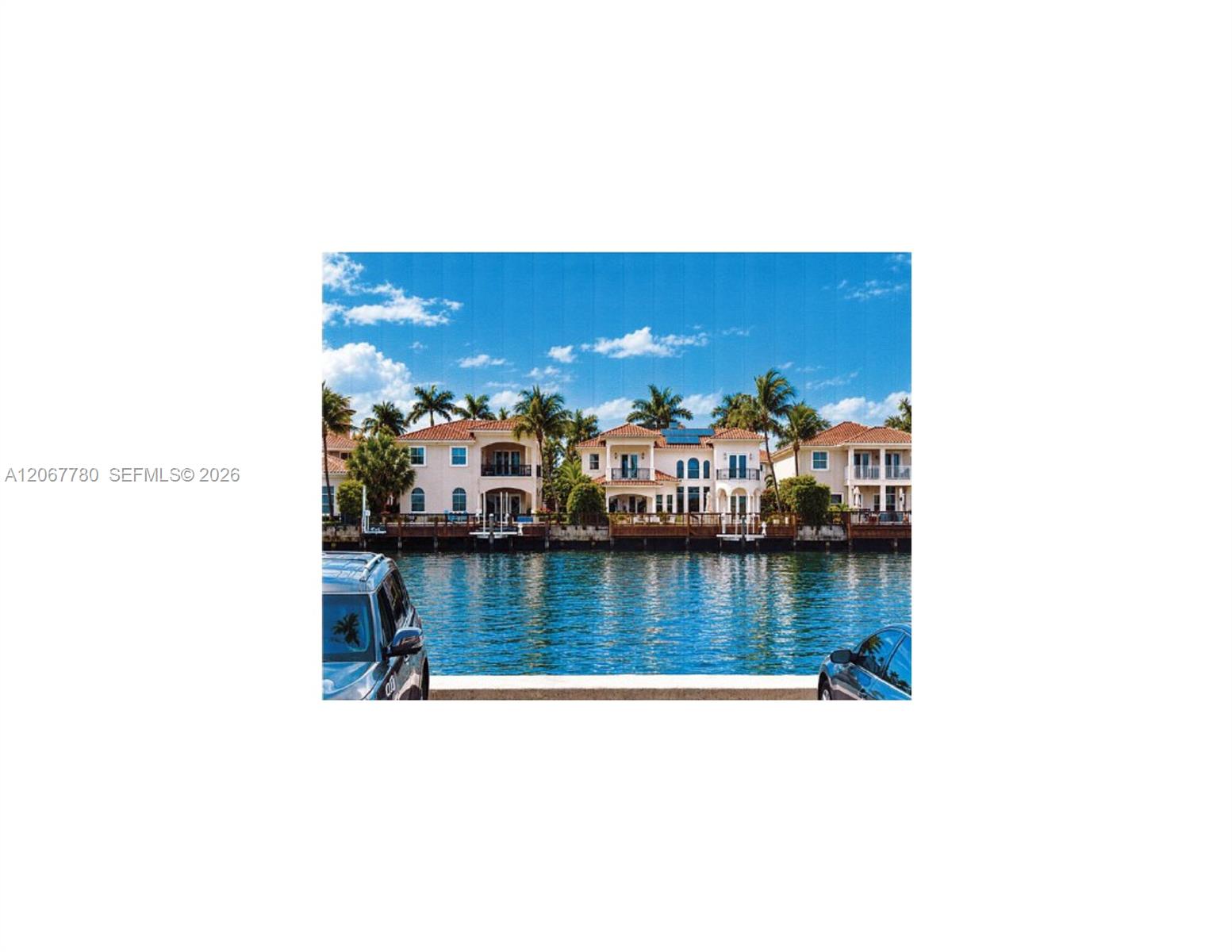 Waterfront residences featuring multi-level balconies, tiled rooflines, and private docks