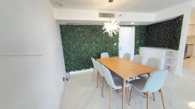 Large-format, light-toned stone-finish flooring with veining, floor-to-ceiling glass sliding doors, and private balcony