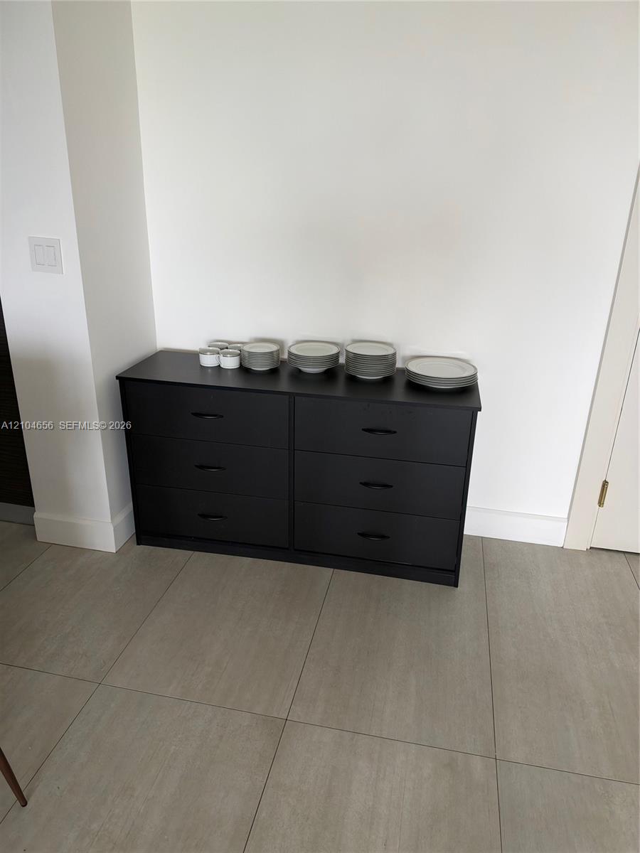 Large-format neutral floor tiling featuring a smooth matte finish