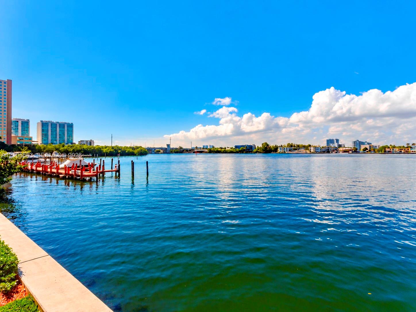 Waterfront property featuring a private dock with multiple boat slips, offering direct water access