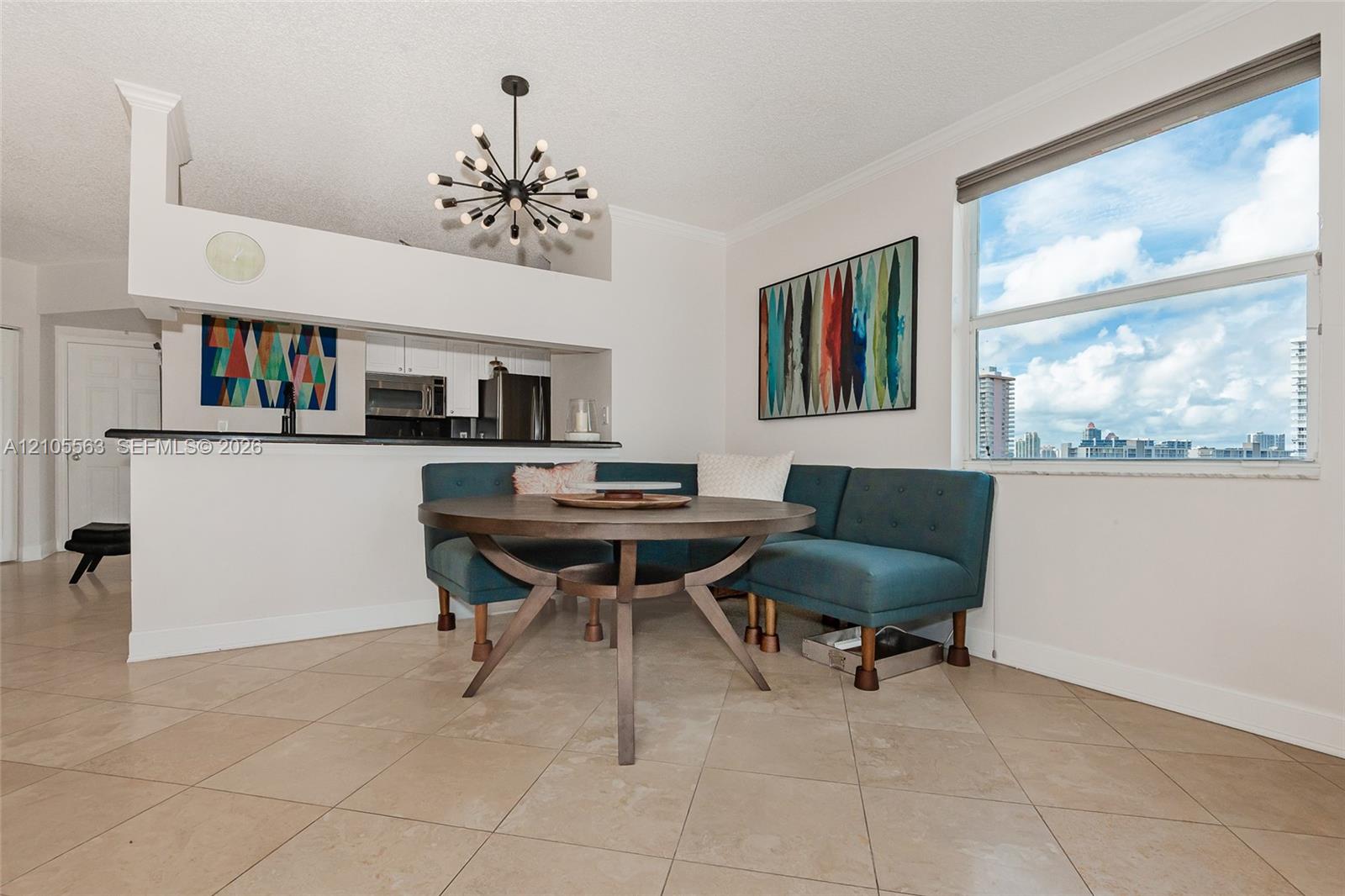 Tile flooring, large window, built-in breakfast bar, contemporary chandelier, recessed kitchen appliances