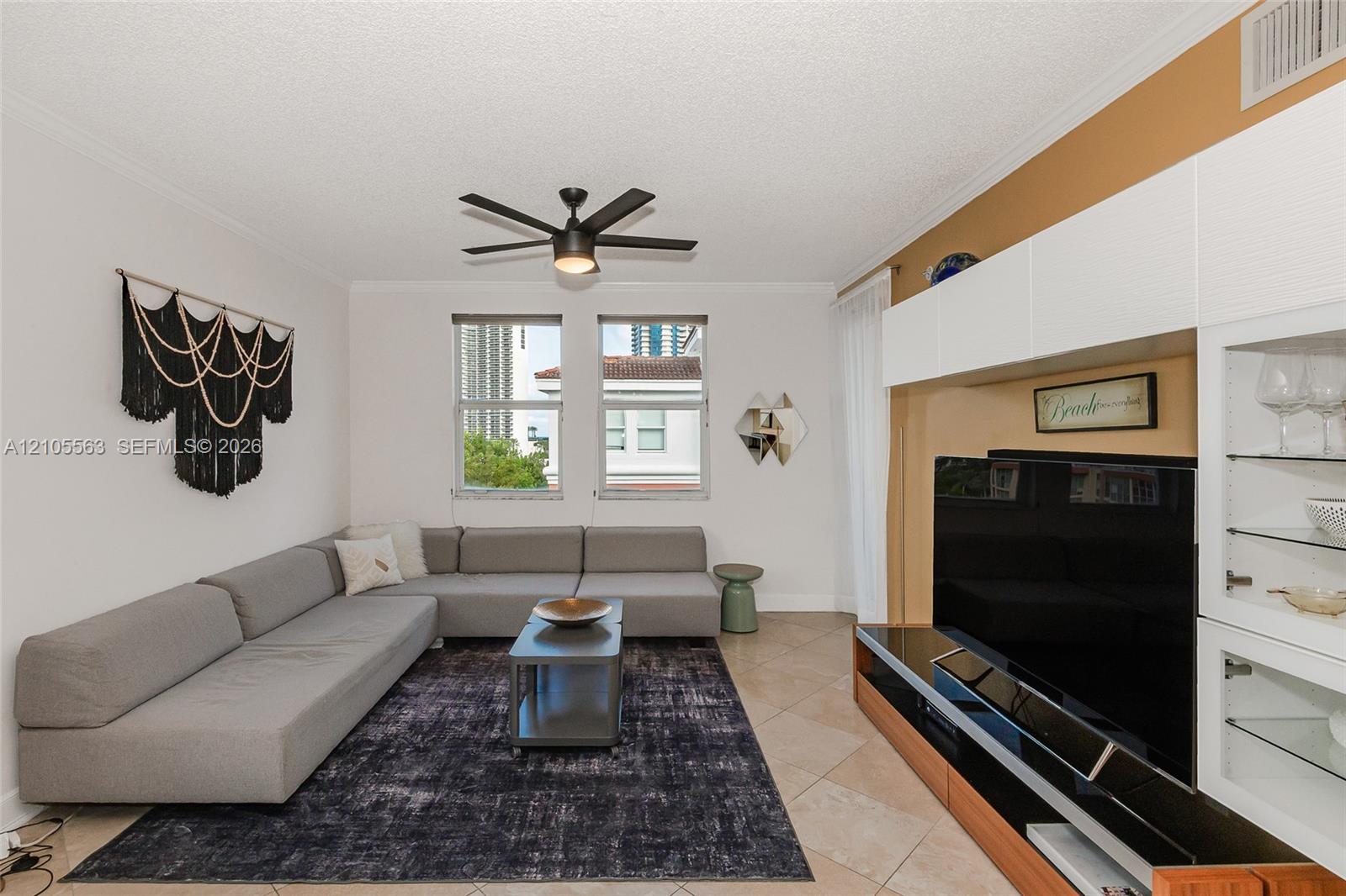Recessed lighting, ceiling fan with integrated light, tiled flooring, built-in media storage with glass shelving, and window with blinds