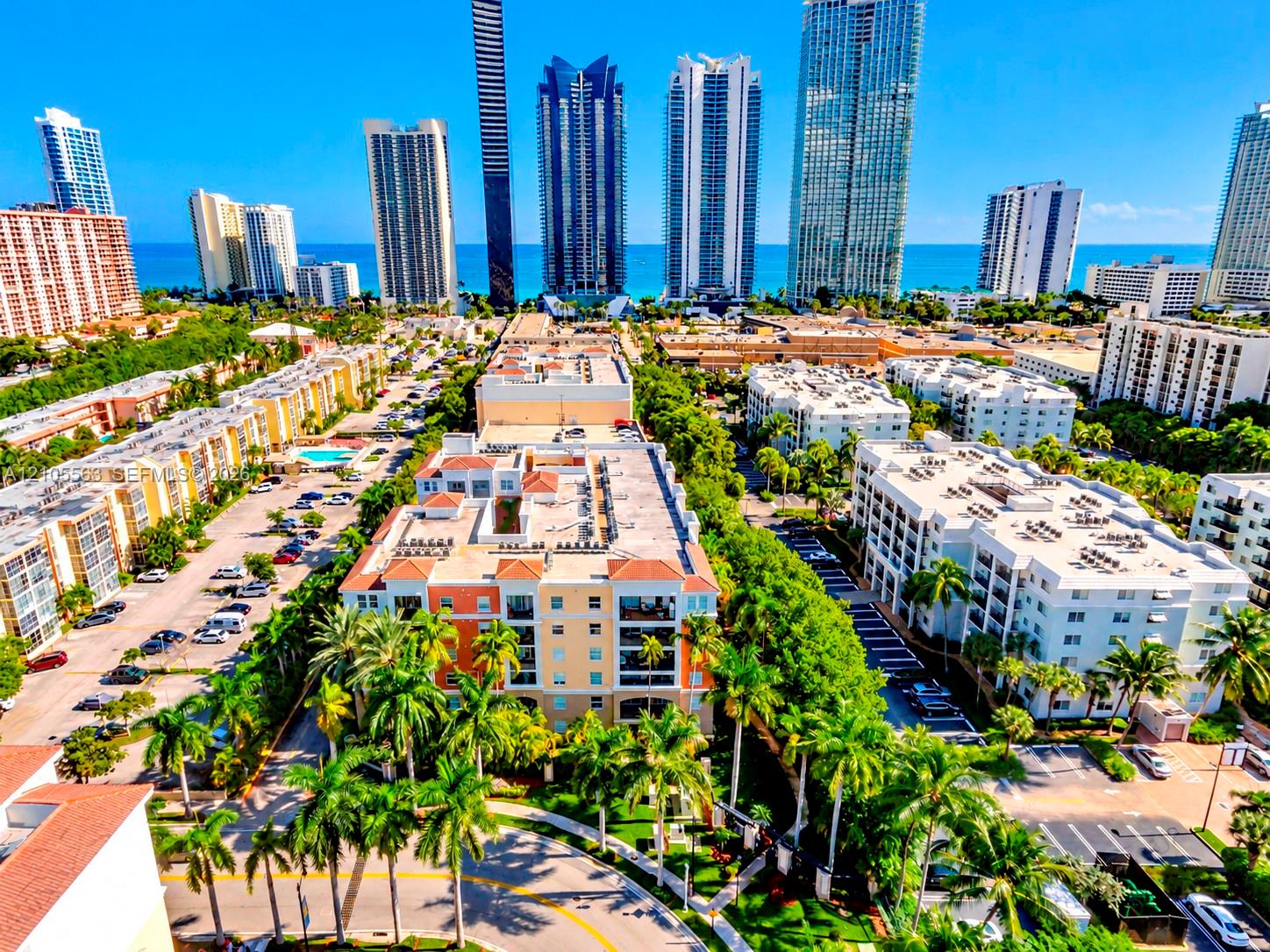Coastal urban landscape featuring high-rise buildings, residential structures, and established landscaping