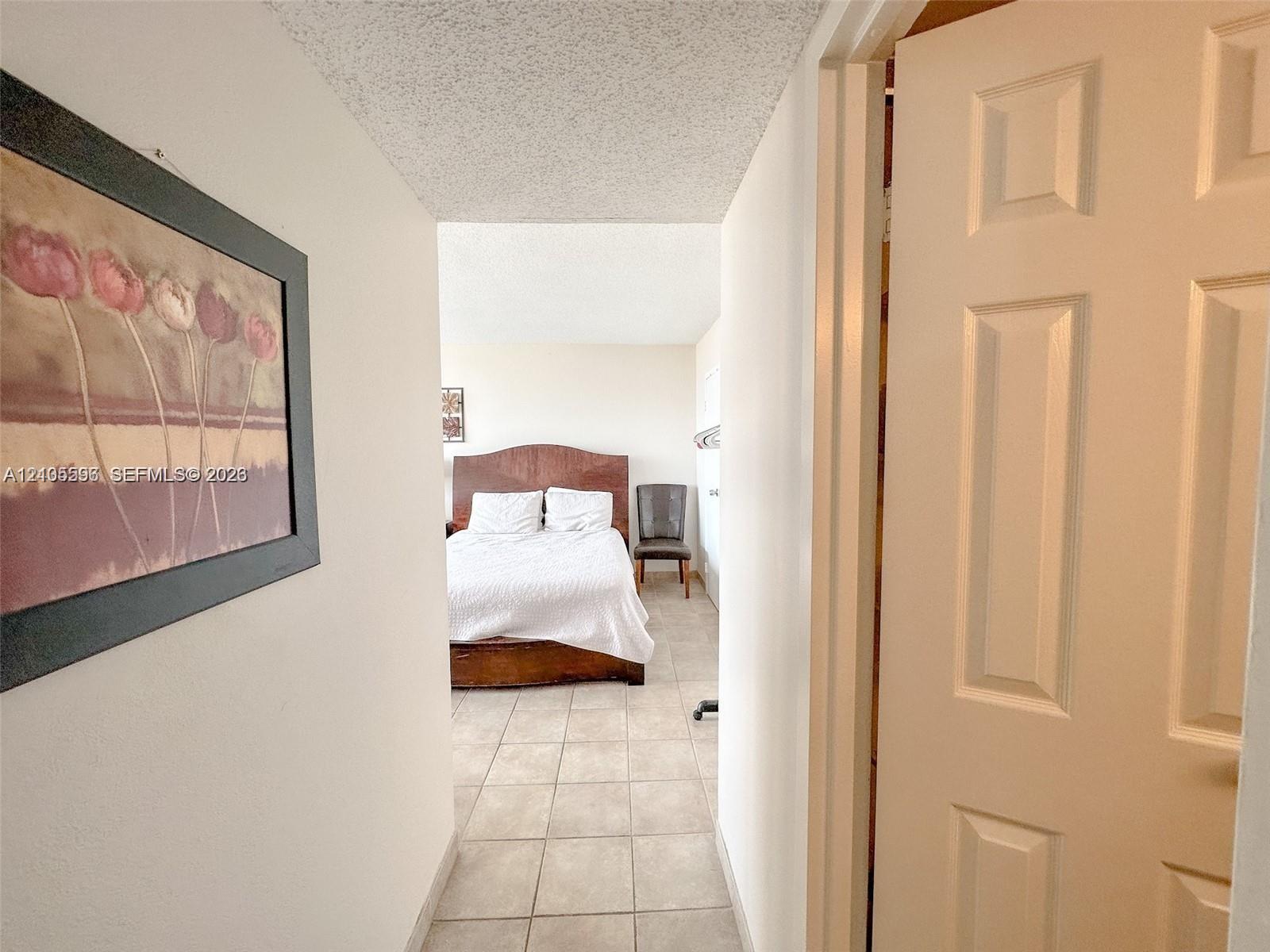 Ceramic tile flooring throughout, white interior doors, and neutral wall tones