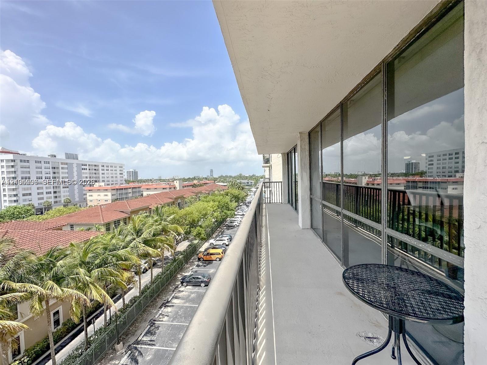 Extended private balcony featuring concrete flooring and metal railings