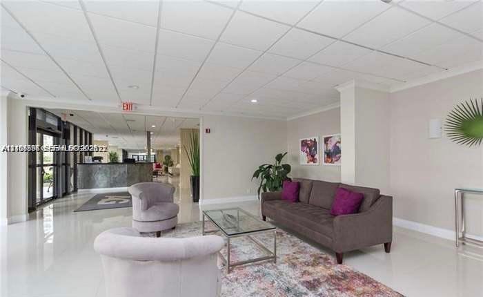 Spacious lobby featuring polished tile flooring, recessed lighting, and a drop ceiling