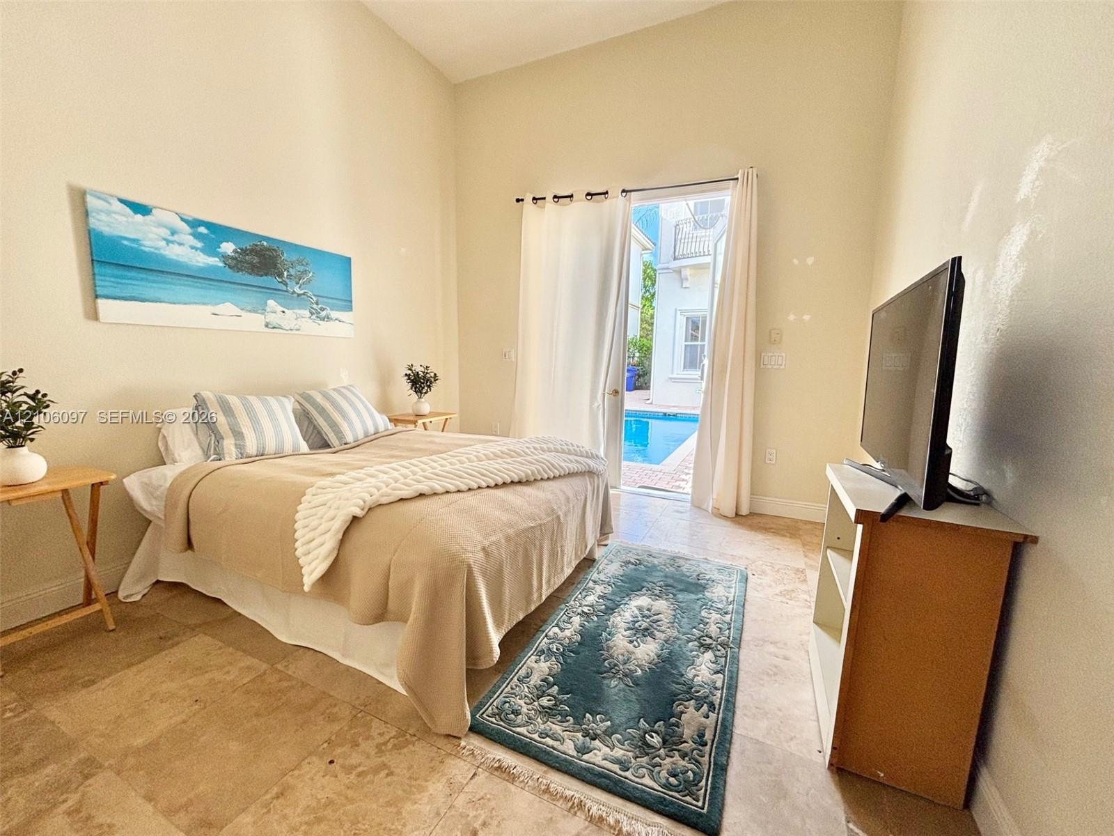 Guest house bedroom overlooking the pool.