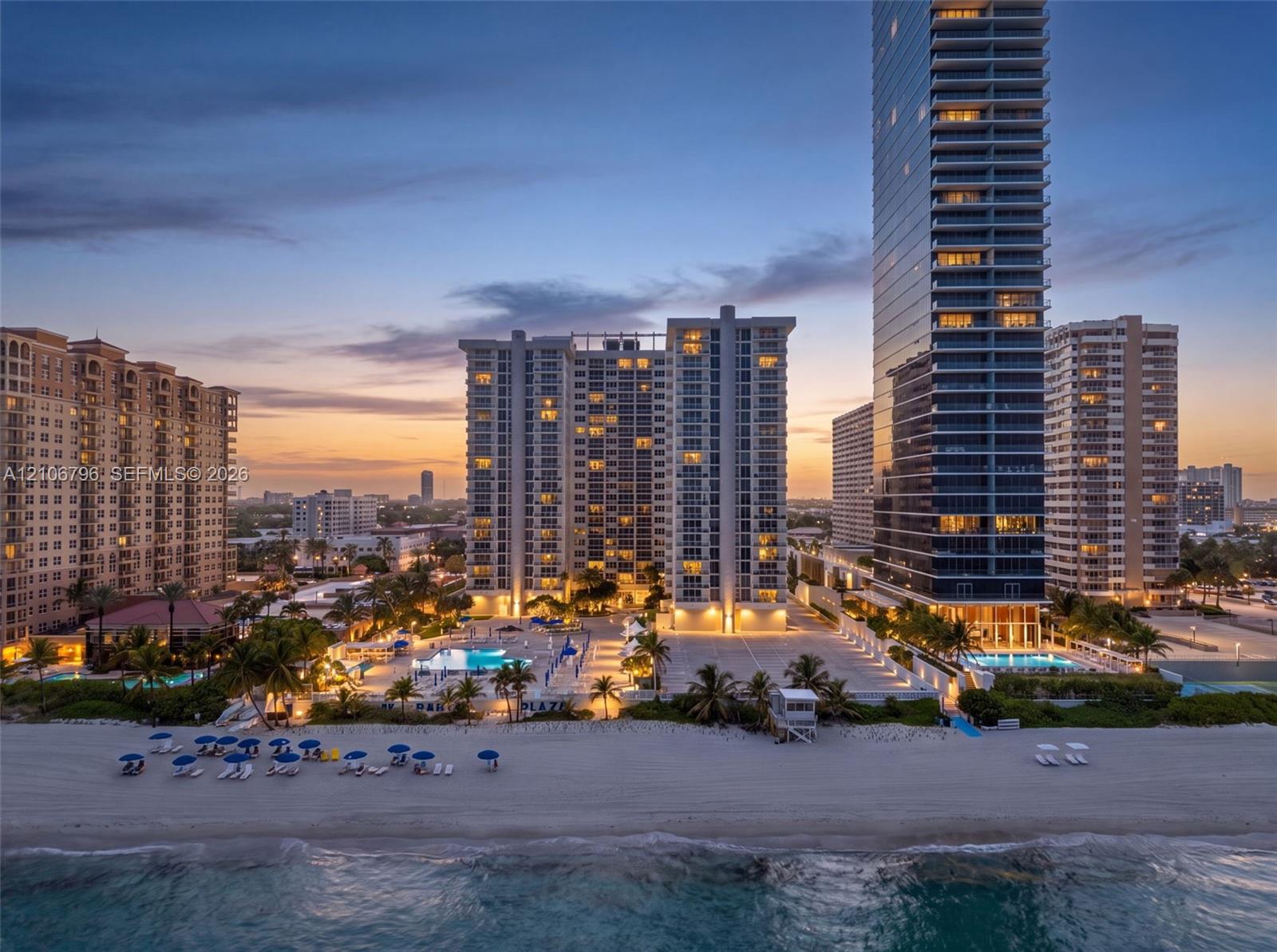 High-rise residential towers featuring direct beach access, multiple outdoor swimming pools, and landscaped grounds
