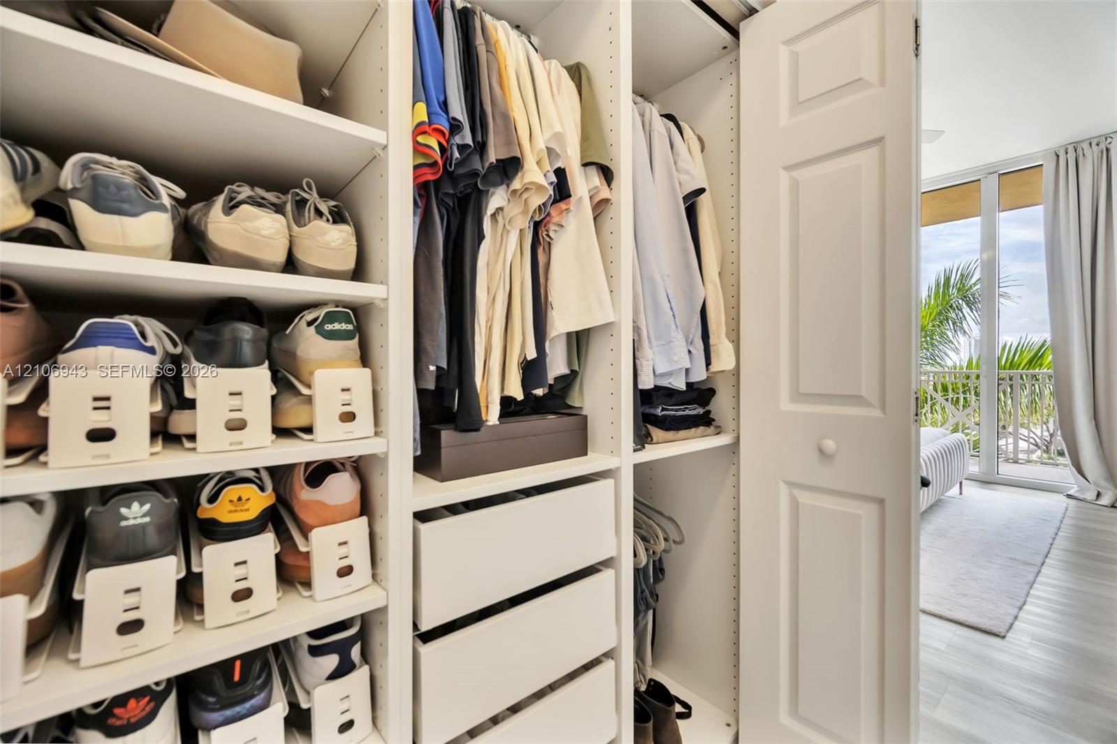 Custom built-in closet organization system featuring adjustable shelving, hanging rods, and integrated pull-out drawers