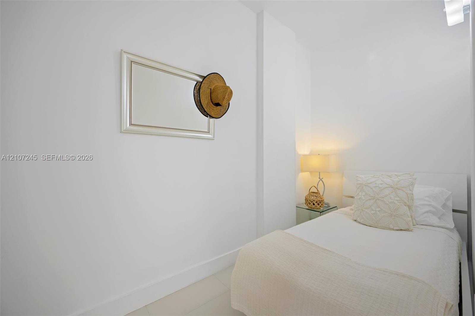 Neutral-toned interior featuring smooth white wall finishes and light-colored flooring