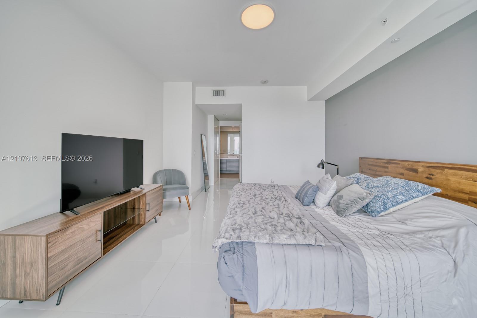 Bright interior featuring polished tile flooring, neutral wall tones, and a built-in flush-mount ceiling light
