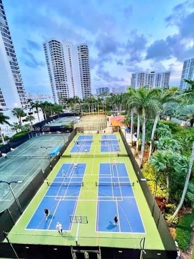 Multiple pickleball courts featuring specialized surfacing, integrated netting systems, perimeter fencing, and high-intensity pole lighting