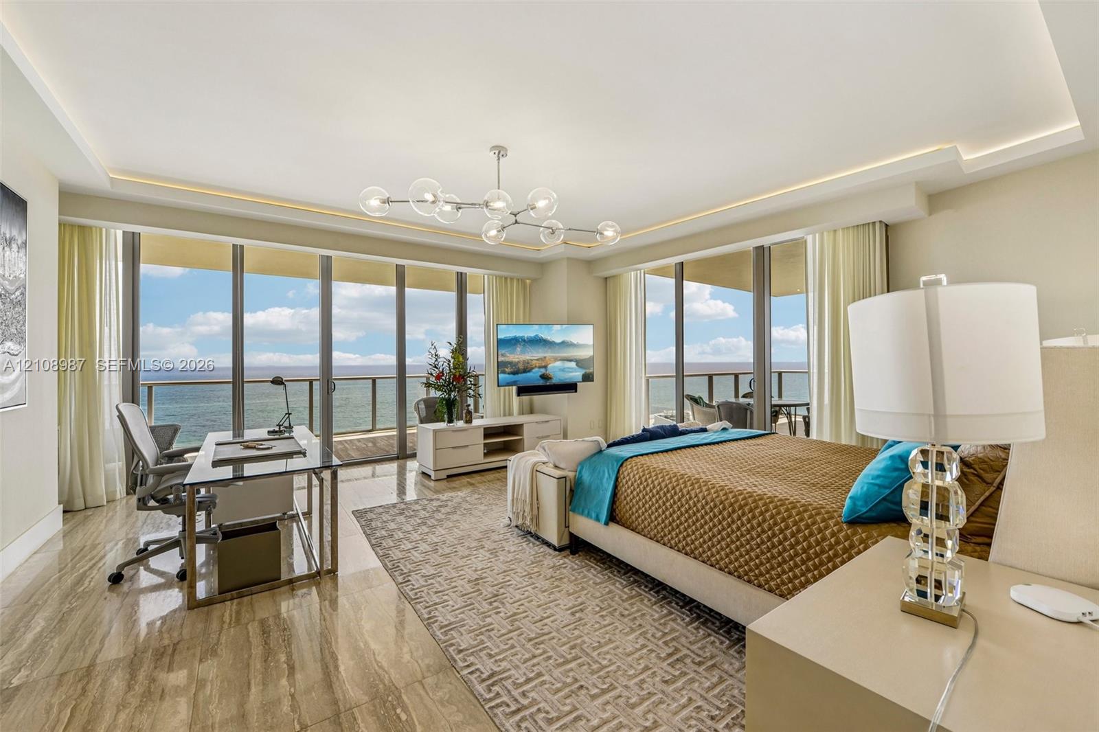 Floor-to-ceiling glass walls, polished stone flooring, recessed ceiling lighting with crown molding, contemporary sputnik-style chandelier, and private balcony access