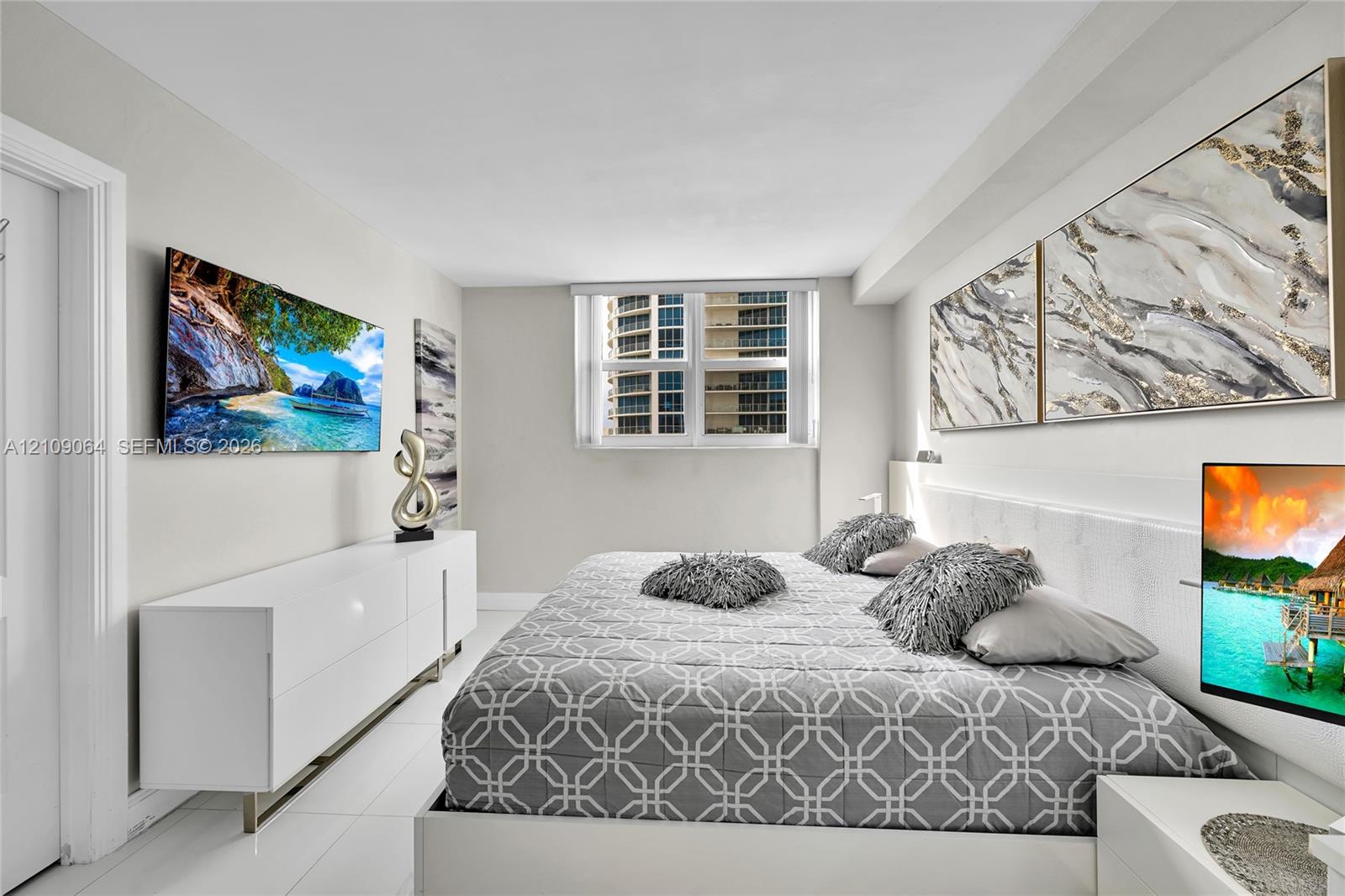 Neutral-toned room with polished light-reflective flooring, crisp white walls, and a multi-pane window