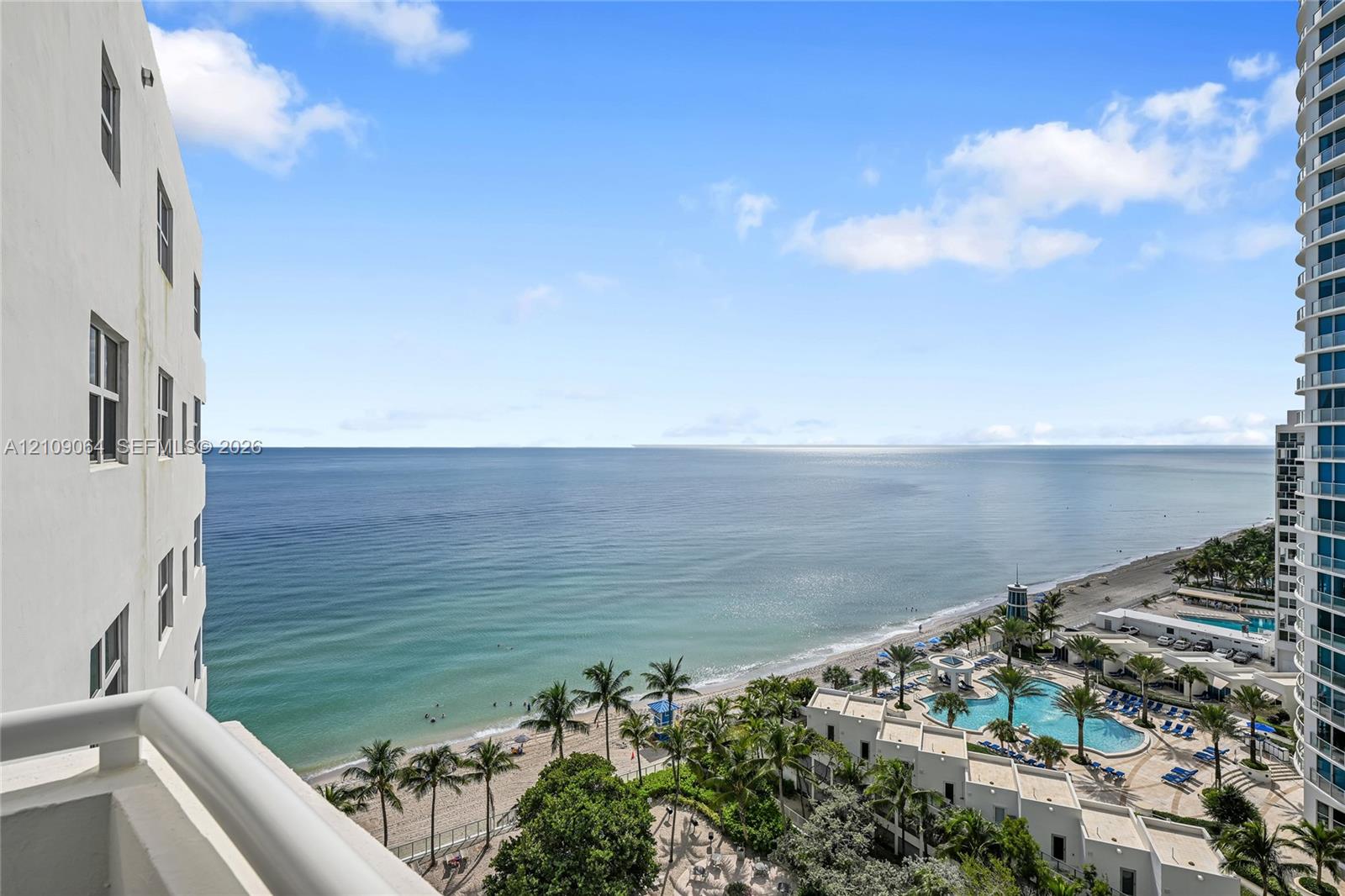 Private balcony featuring glass railings and direct oceanfront scenery