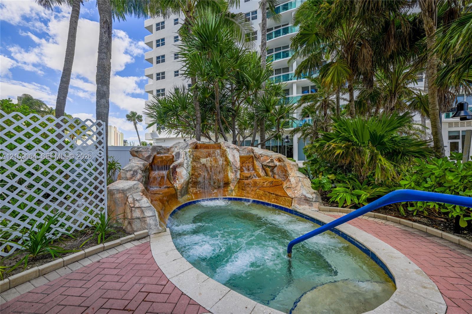 Direct oceanfront access with sandy beach frontage and perimeter security fencing