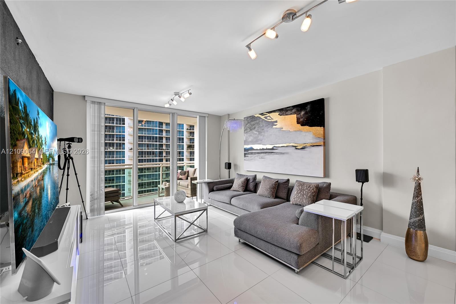 Large format floor tiles, black tiled accent wall, and multi-directional track lighting
