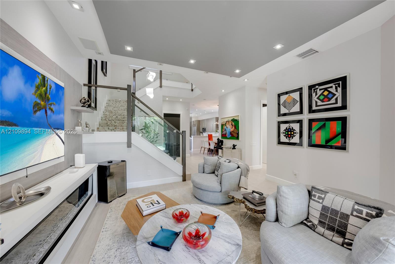Kitchen featuring wood-finish cabinetry, stone countertops, stainless steel appliances, recessed ceiling lighting, and a multi-globe pendant light fixture