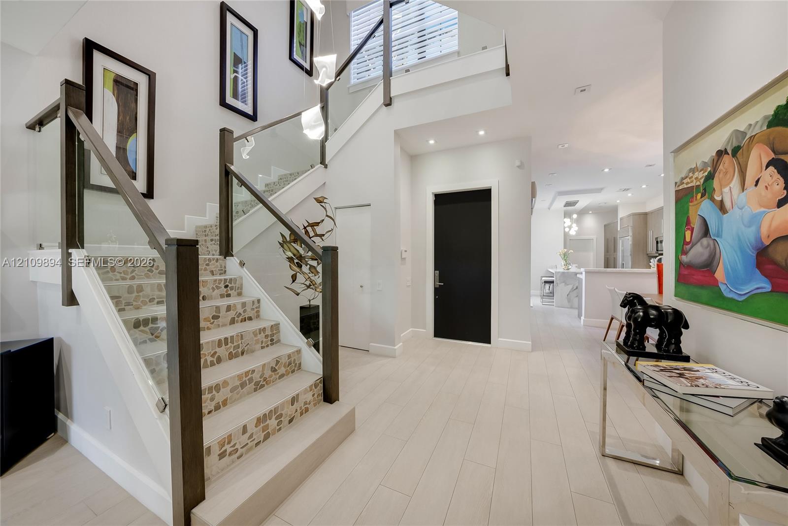 Interior room featuring neutral wall tones, wood-finish flooring, recessed ceiling lighting, and a single-pane window