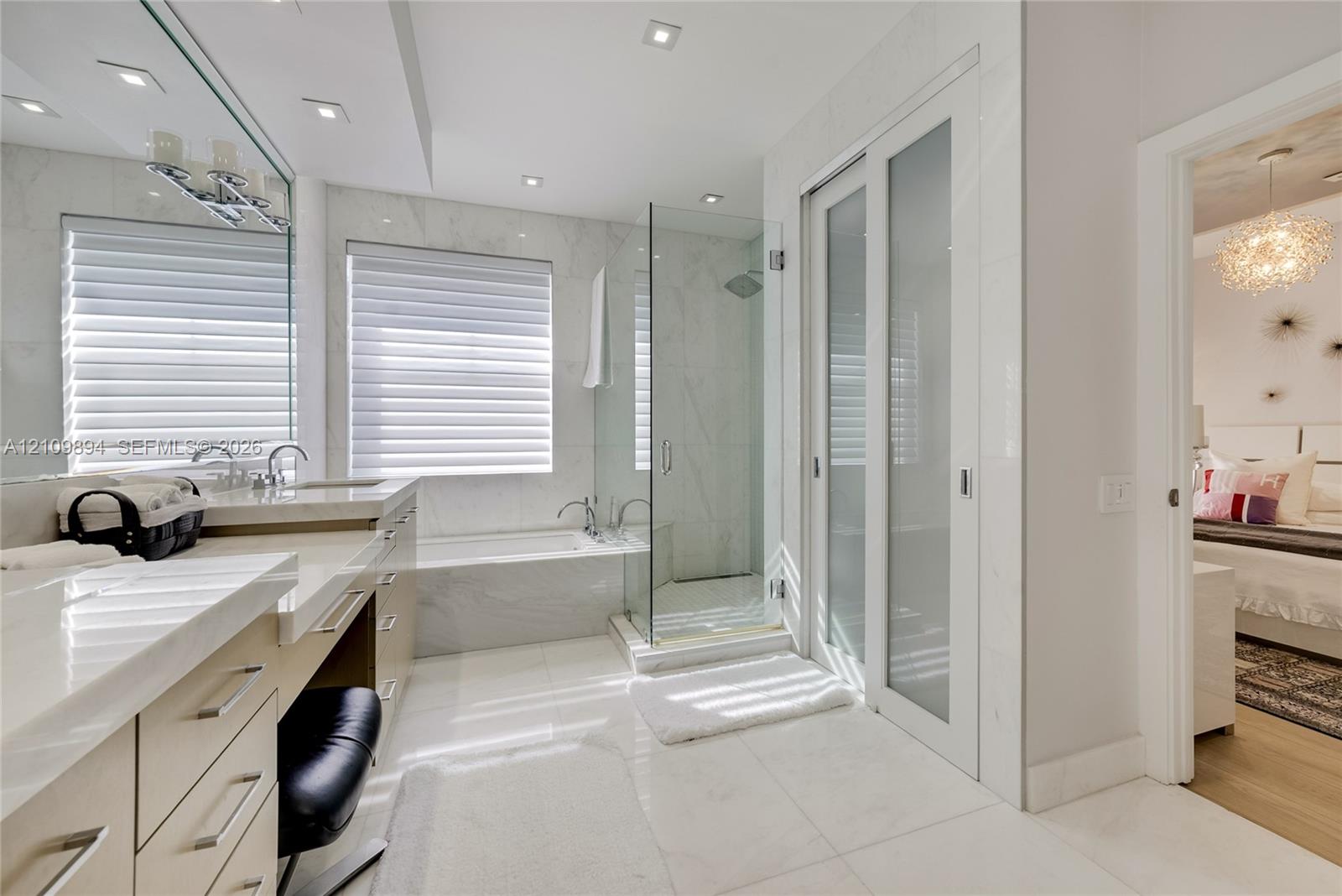 Walk-in closet featuring extensive custom wood-finish built-in cabinetry, multiple open shelving units, and integrated hanging racks