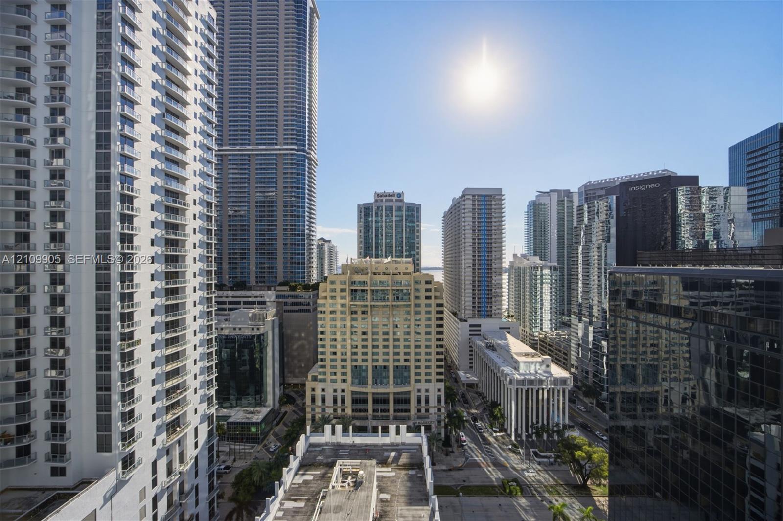 Urban high-rise exterior featuring glass-paneled balconies and a surrounding cityscape